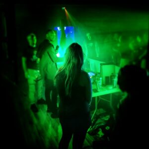 green lighting over DJ performing