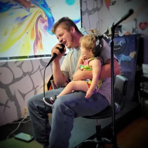 seated singer holding child
