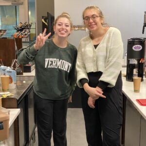 two baristas posing in the front core area of the cafe