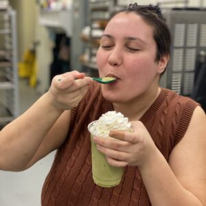 barista spooning blended matcha in their mouth in kitchen at cafe